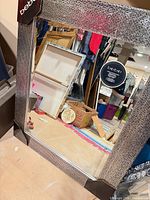 Full view of mirror showing mosaic frame, protective corners, Bebe sticker