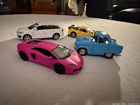 All four toy vehicles grouped on tabletop