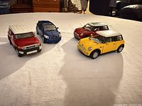 Four diecast toy cars grouped on table