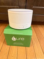 White Pure diffuser on green retail box, front controls visible