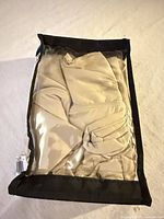 Front view of sealed pouch containing khaki pillowcases
