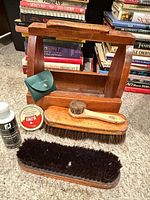 All items arranged: wooden box, two brushes, Kiwi tin, cleaner bottle, green pouch