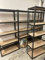 Three assembled metal shelving units side by side showing front and side profiles.