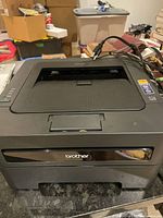 Front view of Brother TN-420 series laser printer with paper input tray visible.