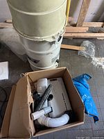 Photo of box containing automatic carpet sweeper and brush attachments