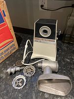 Main vintage Phillips Deluxe Power Centre unit with attached meat grinder parts and grinding discs.