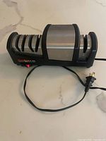 Full view of the Chef's Choice 290 electric knife sharpener showing three sharpening slots and power cord