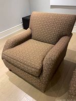Single armchair angled front view showing upholstery and cushion detail