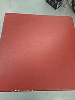 Red three-ring binder with plastic sleeves containing hockey cards.