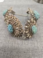 Front view of the antique Egyptian sterling silver bracelet with turquoise scarabs showing detailed filigree and safety chain.