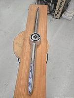 Top view of the complete mounted 1955 Buick grille ornament on wood