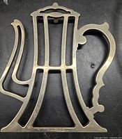 Top view showing kettle shape and open metalwork design, metal surface with some wear.