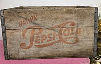 Front view of the wooden crate showing large Pepsi-Cola logo in faded red paint.