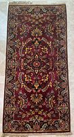 Full view of SAR-U-KHAN area rug showing entire rectangular rug with burgundy base and floral patterns.
