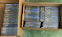 Two boxes filled with Warner Bros classic DVDs laid out to show the spines and titles on the cases.