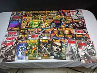Wide view of 43 assorted Filmfax magazines laid out on a surface, showing various colorful and monochrome covers of classic movie themes