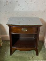 Front view of Gibbard wooden nightstand with removable glass top showing drawer and open shelf beneath.