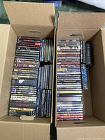 Overhead view of two cardboard boxes containing various DVD and box set cases