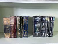 Front view of all Lord of the Rings and Twilight Zone DVD boxes on a shelf in original packaging, showing titles and set sizes.