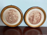 Both framed stipple engravings displayed side by side on wall - one titled Ceres (Summer) and the other Cupid Disarmed by Euphrosine, with round wooden frames and golden inlay.