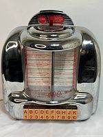 Front view of Thomas 100 Select-O-Matic Collector's Edition Radio showing chrome finish and front panel details with song titles and coin instructions.
