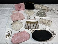 Full lot of ten vintage evening bags laid out on white cloth
