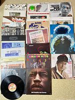 Overview of 23 vinyl record sleeves arranged by artist