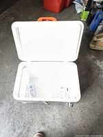 Top view showing white plastic interior with molded compartments inside the cooler.