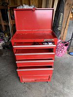 Front view of red Waterloo tool chest with top lid open showing interior and drawers
