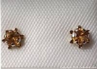 Close-up image showing the citrine stone and white gold setting of the stud earrings.