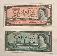 Front view of 1954 Canadian $1 and $2 banknotes showing Queen Elizabeth II and serial numbers.