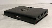 Black leather folder with embossed Royal Canadian Mint crest and snap closure.