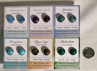 Photo of all six pairs of earrings on cards with a dime for size reference.