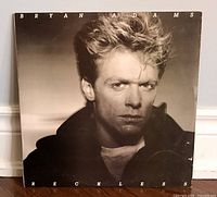 Photo of Bryan Adams Reckless album cover sleeve showing a black and white portrait of Bryan Adams.