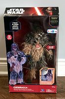 Front view of unopened Star Wars Chewbacca animatronic toy in original packaging featuring box art with Kylo Ren and branded labels.