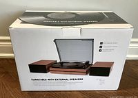 Front of boxed RetroLife turntable with two external speakers displayed
