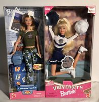 Route 66 Adventure Barbie and University Cheerleader Barbie in unopened packaging, displayed side by side.