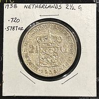 Obverse of silver coin showing denomination 2½ G, date 1938, and coat of arms with crown, mounted in protective holder with handwritten label.
