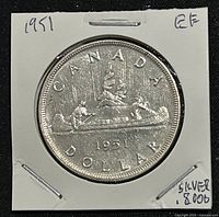 Reverse of the coin showing the canoe with paddlers and fur load with date and country inscription.