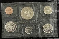 Photo showing six Canadian coins from 1973 sealed in plastic compartments each with unique designs and sizes.