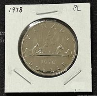 Front view of the 1978 Canadian 1 Dollar coin showing the canoe scene with two paddlers under the word "CANADA" and the date "1978" with "DOLLAR" at the bottom.