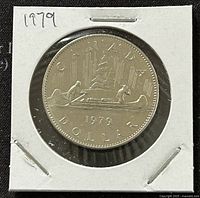 Reverse side of the 1979 Canadian one dollar coin showing the canoe scene, year, and inscriptions.