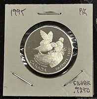 Front of 1995 Canadian 50 cent silver proof coin showing Atlantic Puffin birds design and inscriptions including 'CANADA', '50 CENTS', '1995', and 'SILVER 9250'.