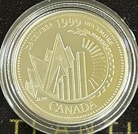 Reverse side of 1999 Canadian silver proof coin displaying December design with mountain, sunburst, bar graph and inscriptions.
