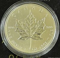 Reverse side of the 2003 Canadian Silver Maple Leaf coin showing maple leaf design with purity and weight inscriptions.