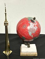 Front view of the metal CN Tower model and side view of 6-inch world globe on marble base.