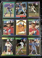 Front view of 9 Montreal Expos baseball player trading cards arranged in 3 rows, 3 cards each, all in protective sleeves.