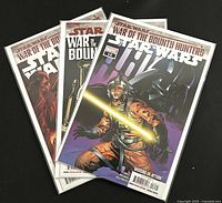 Three Marvel Star Wars War of the Bounty Hunters comic books in protective sleeves. Covers include detailed and colorful artwork.