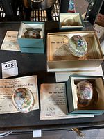 Five Lenox China Easter eggs in original boxes with certificates on display