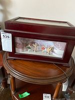 Full view of the music box on a round table showing front ballet figurines display in Nutcracker theme.